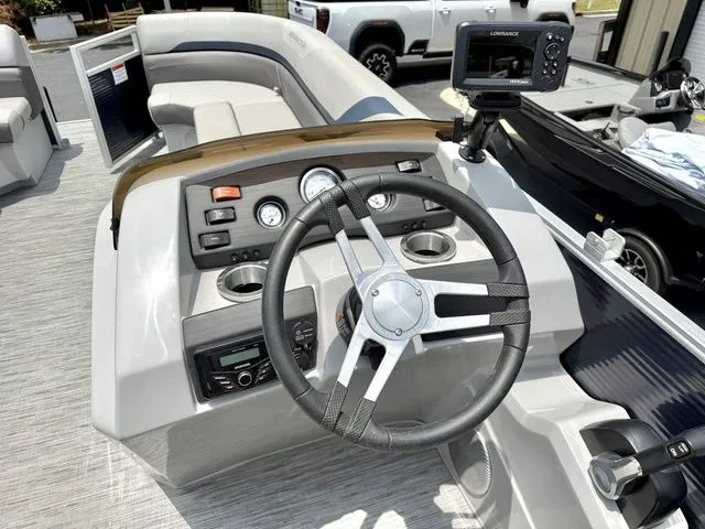 Slide: The Image of The image shows the helm of a Bennington 22 SXSAPG pontoon boat with modern instruments. - 6