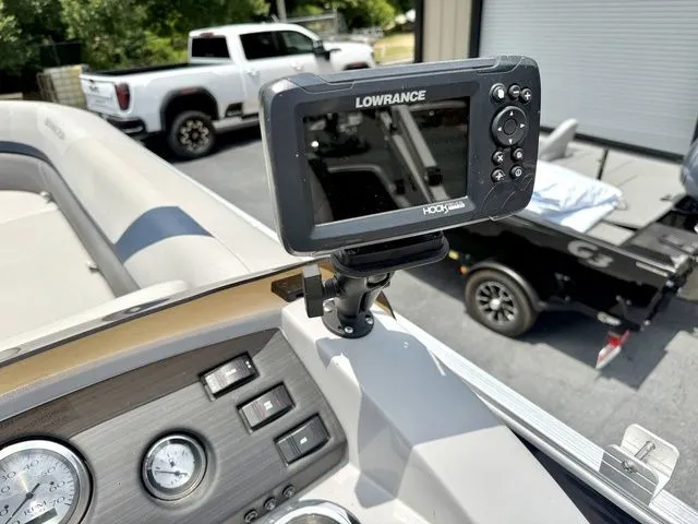 Slide: The Image of A Lowrance fish finder is mounted on a Bennington boat, surrounded by dashboard and instruments. - 10