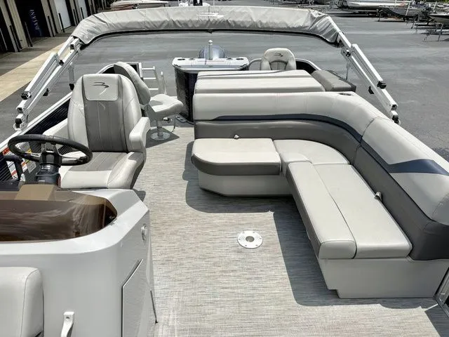 Slide: The Image of The image shows the deck of a Bennington 22 SXSAPG pontoon boat with gray upholstery. - 3