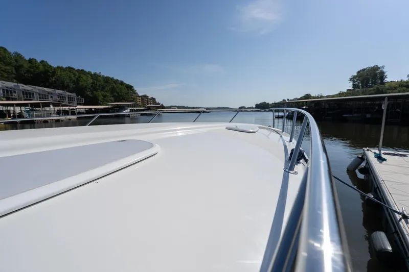 Slide: The Image of 2007 Formula 400 Super Sport boat docked on a calm lake under clear blue skies. - 54