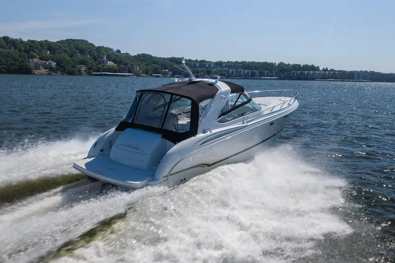 Slide: The Image of 2007 Formula 400 Super Sport boat cruising on a scenic lake. - 4