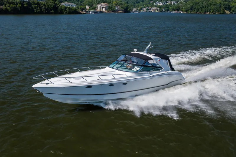 Slide: The Image of 2007 Formula 400 Super Sport boat cruising on a lake with scenic background. - 2