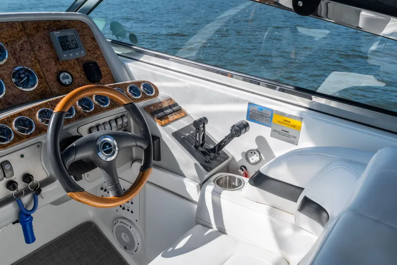 Slide: The Image of 2007 Formula 400 Super Sport boat cockpit with wooden steering wheel and control panel. - 21