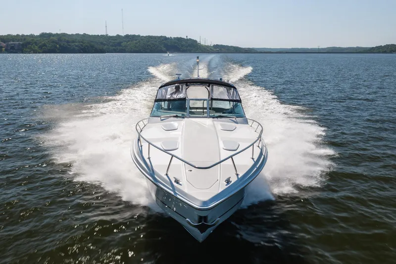 Slide: The Image of 2007 Formula 400 Super Sport boat cruising on a lake with scenic background. - 7