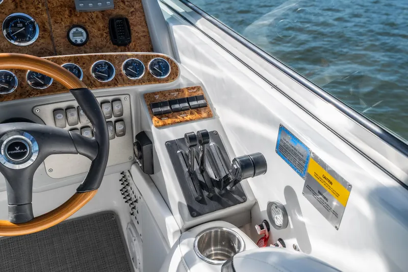 Slide: The Image of 2007 Formula 400 Super Sport boat dashboard with steering wheel and control panel. - 26