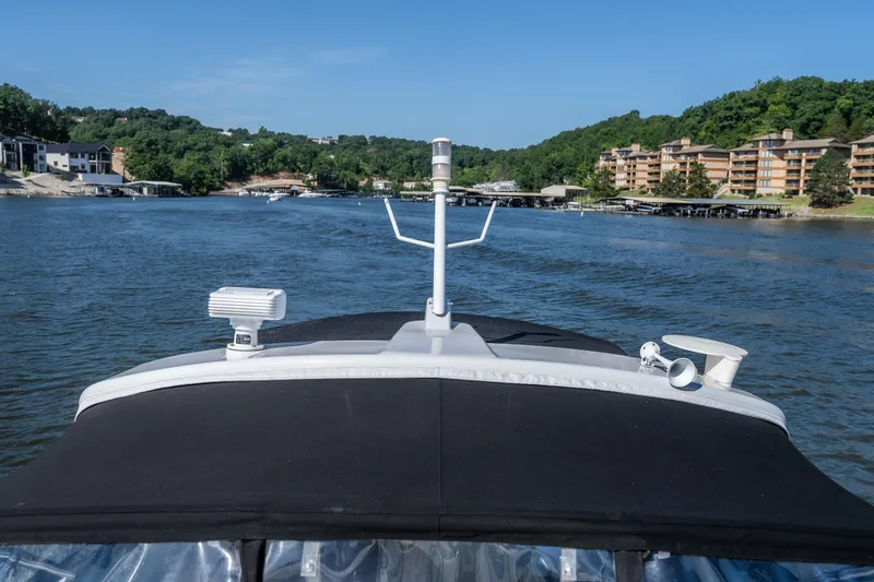Slide: The Image of 2007 Formula 400 Super Sport boat cruising on a scenic lake with waterfront buildings. - 18