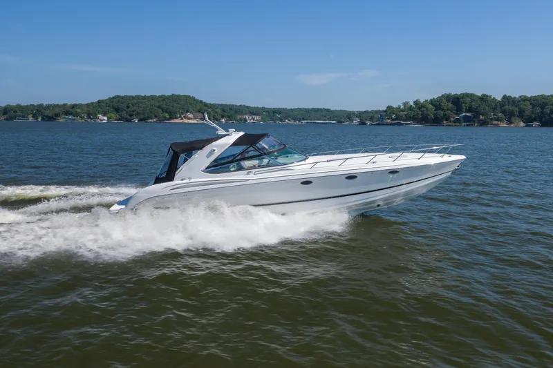 Slide: The Image of 2007 Formula 400 Super Sport boat cruising on a lake under clear blue skies. - 13