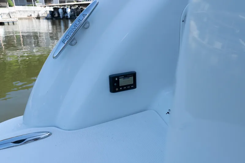 Slide: The Image of 2007 Formula 400 Super Sport boat detail with control panel and logo, dockside view. - 55
