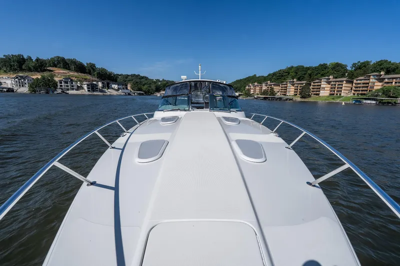 Slide: The Image of 2007 Formula 400 Super Sport yacht cruising on a scenic lake with waterfront homes. - 17