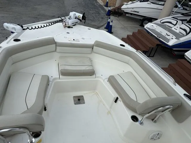 Slide: The Image of The image shows the cockpit of a 2015 NauticStar 231 Coastal boat with beige seating. - 6
