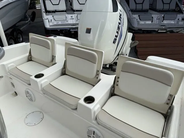 Slide: The Image of Three cushioned seats with cup holders on a boat, Suzuki engine in the background. - 3