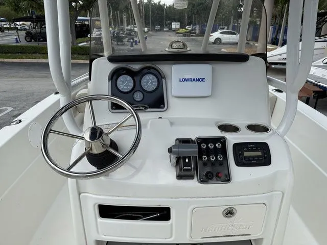 Slide: The Image of The image shows the helm of a 2015 NauticStar 231 Coastal boat. - 5