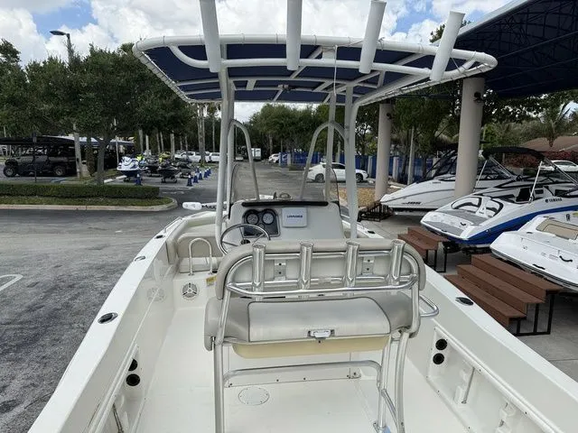 Slide: The Image of The image shows a 2015 NauticStar 231 Coastal boat with an open cockpit and blue sunshade. - 16