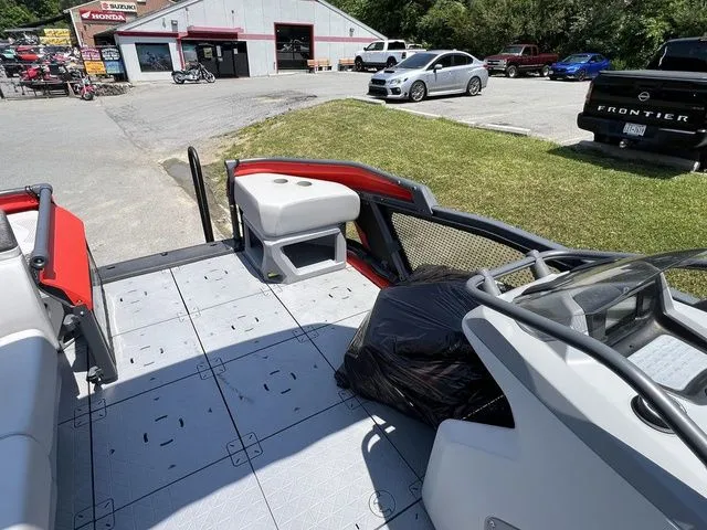 Slide: The Image of The image shows the deck of a 2022 Sea-Doo Switch Cruise 18, parked in a lot. - 18