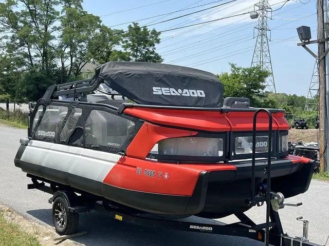 Slide: The Image of A 2022 Sea-Doo Switch Cruise 18 on a trailer, featuring a red and black design. - 10