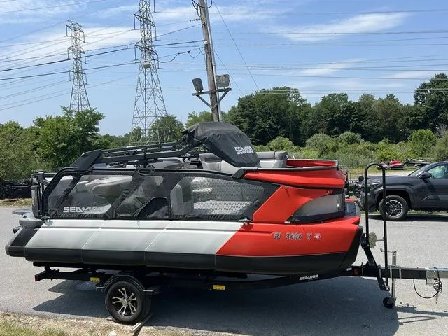 Slide: The Image of 2022 Sea-Doo Switch Cruise 18 on a trailer, surrounded by trees and power lines. - 9