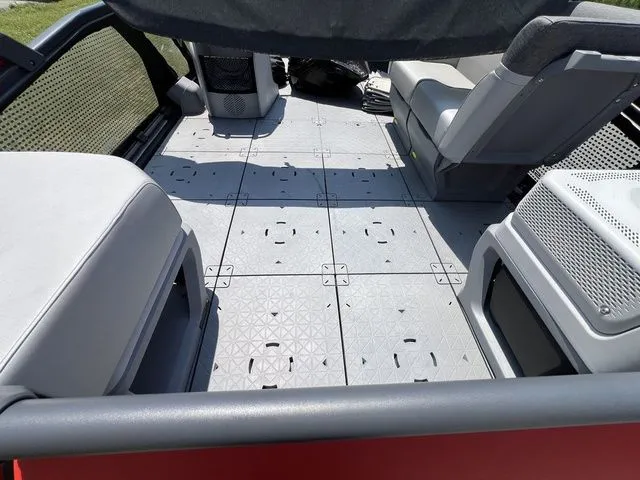Slide: The Image of Interior of a 2022 Sea-Doo Switch Cruise 18 with gray seating and textured flooring. - 11