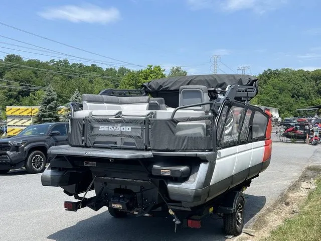 Slide: The Image of A 2022 Sea-Doo Switch Cruise 18 on a trailer, surrounded by trees and cars. - 6