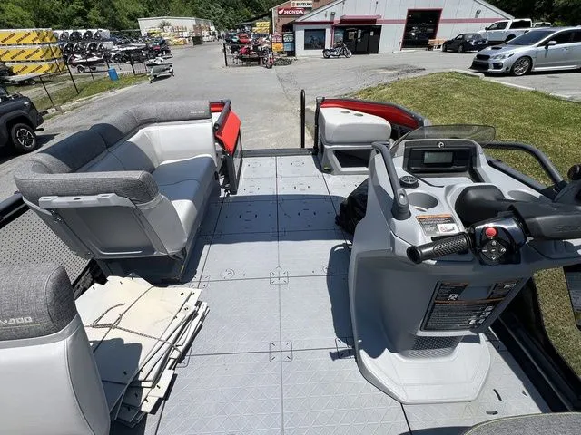 Slide: The Image of The image shows the deck of a 2022 Sea-Doo Switch Cruise 18 with gray seating and a helm station. - 13