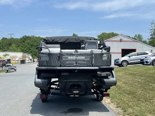 Slide: The Image of Rear view of a 2022 Sea-Doo Switch Cruise 18 on a trailer, surrounded by buildings. - 5