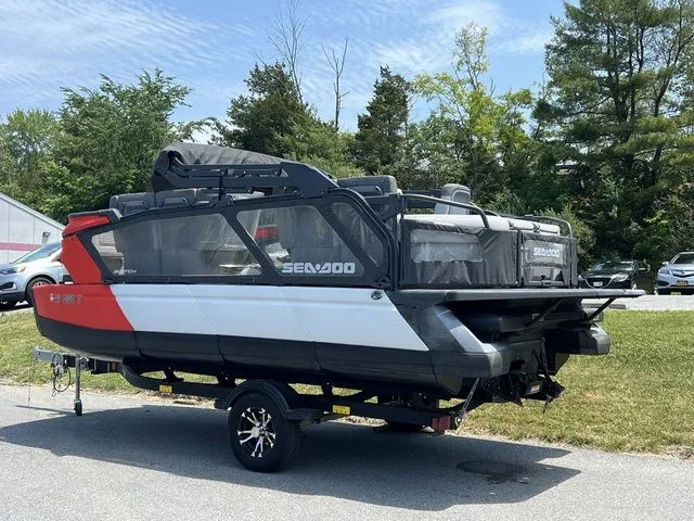 Slide: The Image of A 2022 Sea-Doo Switch Cruise 18 on a trailer, surrounded by trees and cars. - 3