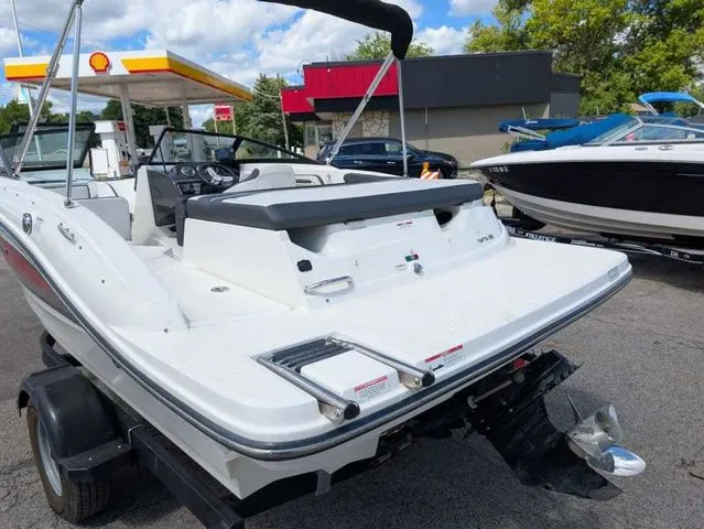 Slide: The Image of A 2017 Sea Ray SPX 190 boat on a trailer near a gas station. - 14