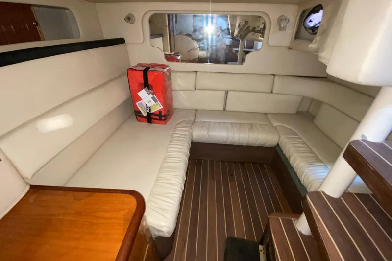 Slide: The Image of 2001 Sea Ray 340 Sundancer cabin interior with white seating and wooden flooring. - 40