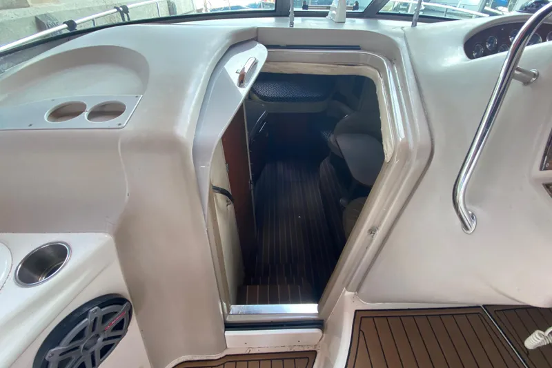 Slide: The Image of 2001 Sea Ray 340 Sundancer cabin entrance with sleek interior and wood flooring. - 27