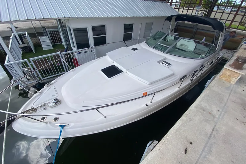 Slide: The Image of 2001 Sea Ray 340 Sundancer docked at marina, featuring sleek design and spacious deck. - 4