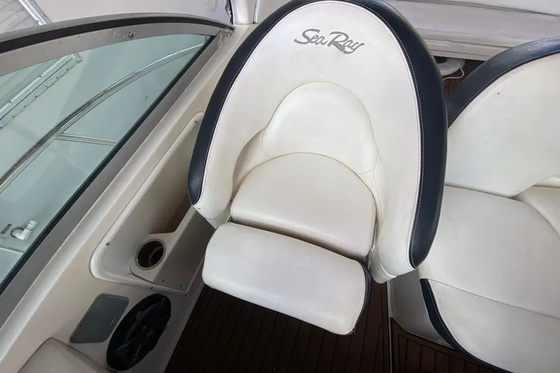 Slide: The Image of Captain's chair on 2001 Sea Ray 340 Sundancer boat, featuring white upholstery and logo. - 20