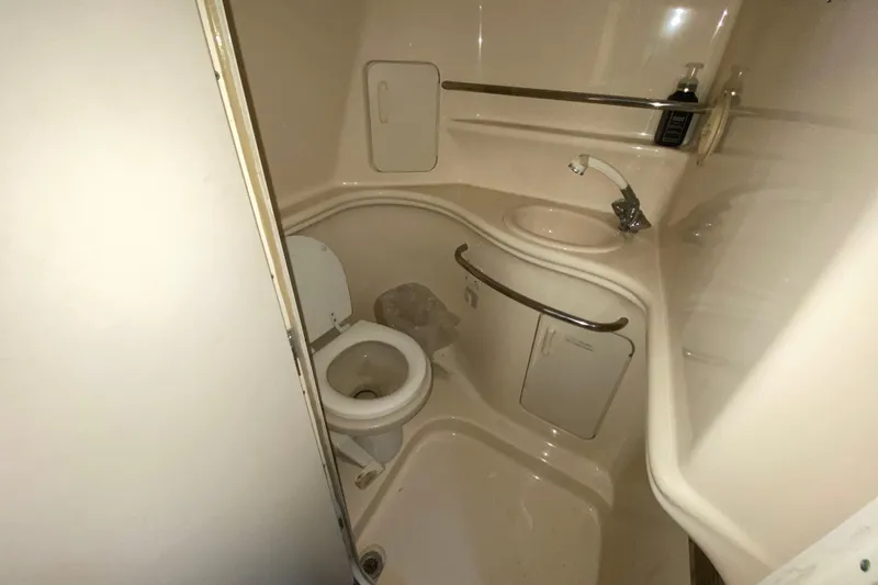 Slide: The Image of Compact bathroom in 2001 Sea Ray 340 Sundancer yacht, featuring toilet and sink. - 38