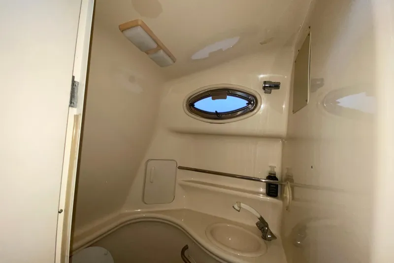 Slide: The Image of Interior of 2001 Sea Ray 340 Sundancer bathroom with sink and porthole window. - 39