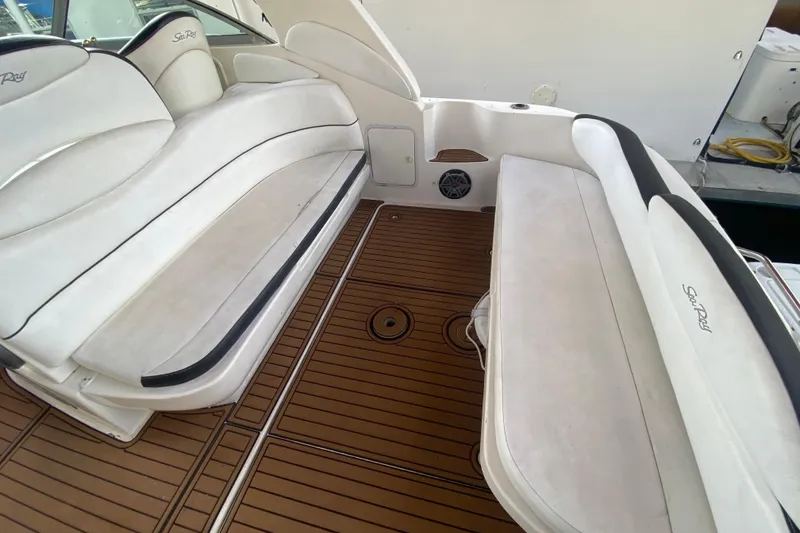 Slide: The Image of 2001 Sea Ray 340 Sundancer interior with white seating and teak flooring. - 17
