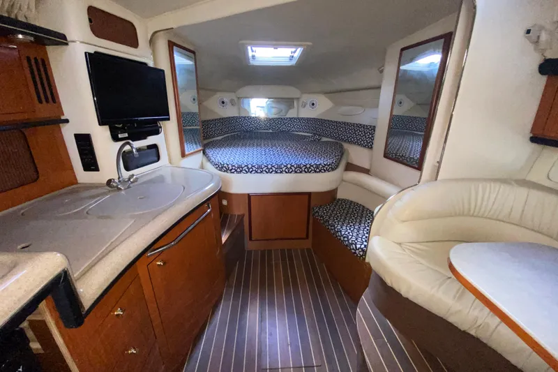 Slide: The Image of Interior of 2001 Sea Ray 340 Sundancer yacht with cozy cabin and kitchenette. - 33