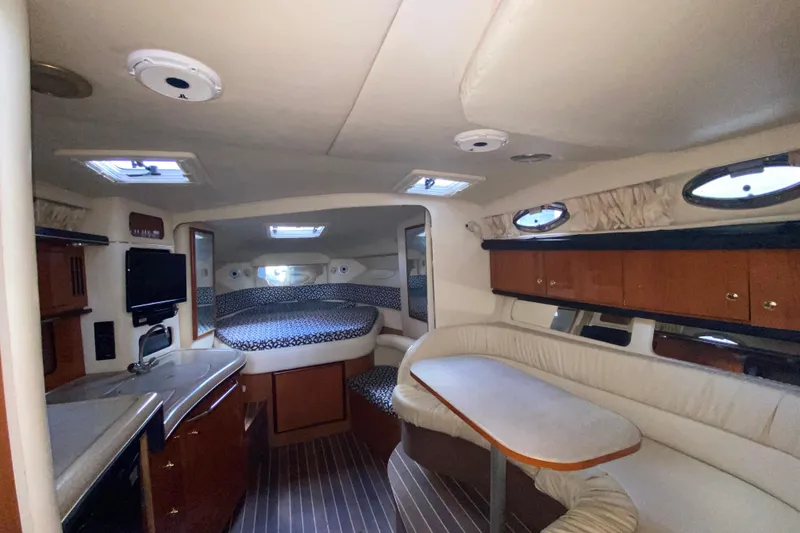 Slide: The Image of Interior of 2001 Sea Ray 340 Sundancer yacht with cozy seating and modern amenities. - 29