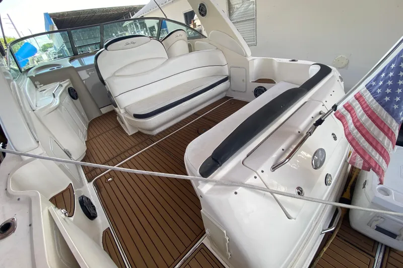 Slide: The Image of 2001 Sea Ray 340 Sundancer boat interior with seating and American flag. - 15