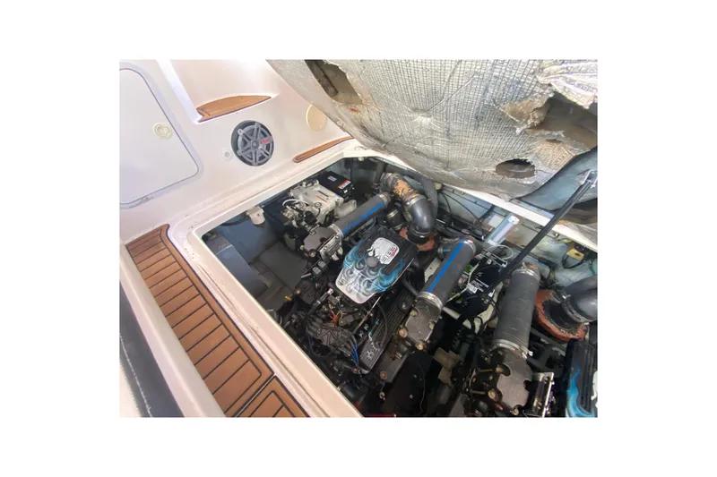 Slide: The Image of Engine compartment of a 2001 Sea Ray 340 Sundancer boat, showcasing mechanical components. - 49