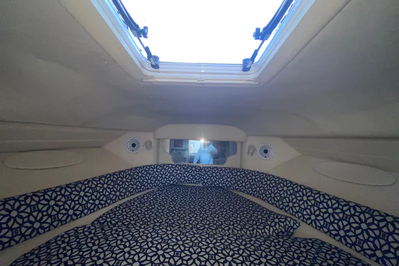 Slide: The Image of Interior cabin of 2001 Sea Ray 340 Sundancer with patterned bedding and overhead hatch. - 37