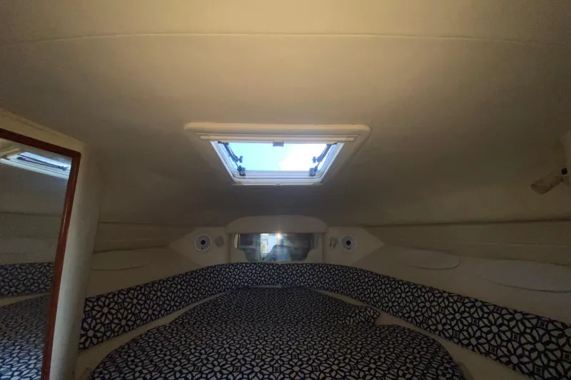 Slide: The Image of Interior cabin of 2001 Sea Ray 340 Sundancer with patterned bedding and overhead hatch. - 36