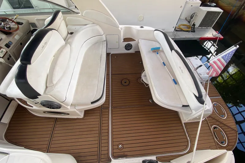 Slide: The Image of 2001 Sea Ray 340 Sundancer boat interior with seating and American flag. - 13