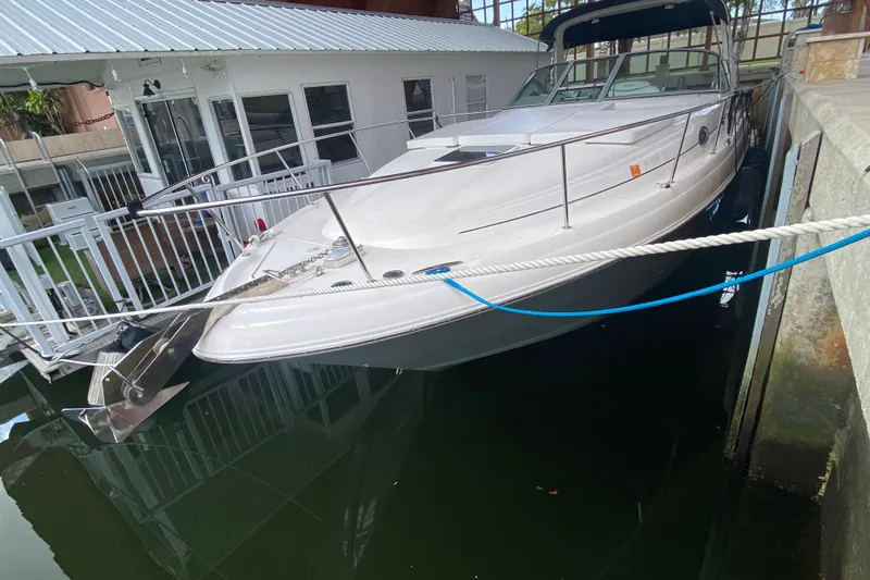 Slide: The Image of 2001 Sea Ray 340 Sundancer docked beside a waterfront building. - 1