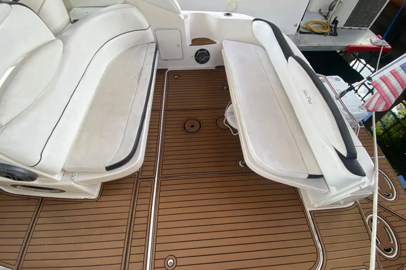 Slide: The Image of 2001 Sea Ray 340 Sundancer boat interior with white seating and teak-style flooring. - 14