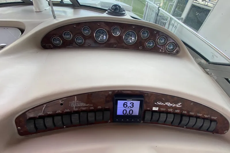 Slide: The Image of Dashboard of a 2001 Sea Ray 340 Sundancer boat with gauges and controls. - 25