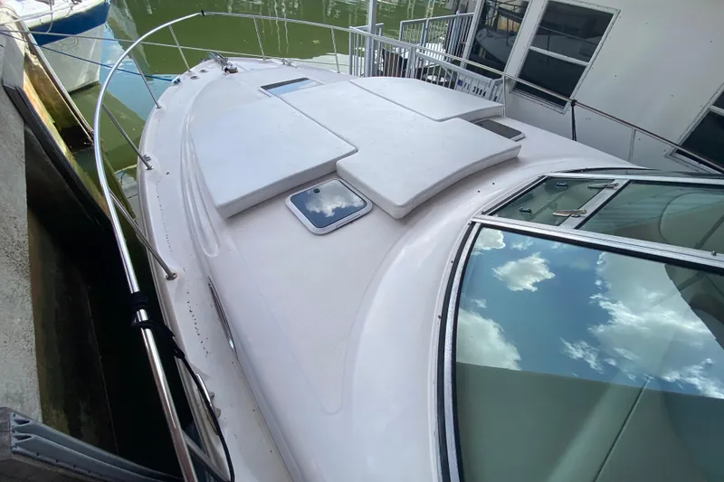 Slide: The Image of 2001 Sea Ray 340 Sundancer yacht docked, featuring sleek deck and reflective windows. - 5