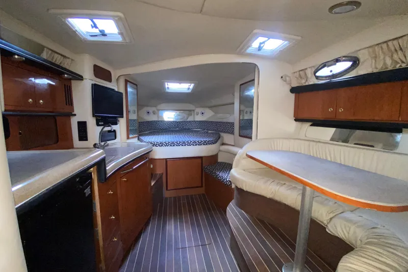 Slide: The Image of 2001 Sea Ray 340 Sundancer cabin interior with kitchenette, seating, and sleeping area. - 30