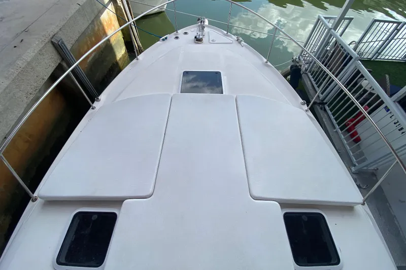 Slide: The Image of Bow view of a 2001 Sea Ray 340 Sundancer docked at a marina. - 8