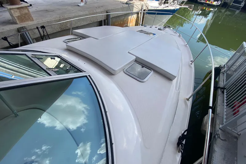 Slide: The Image of 2001 Sea Ray 340 Sundancer docked, showcasing sleek design and spacious deck. - 6