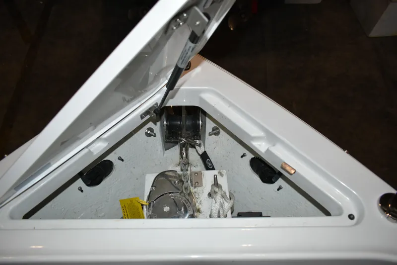 Slide: The Image of Anchor compartment of 2023 Cobalt R8 boat, featuring winch and rope storage. - 27