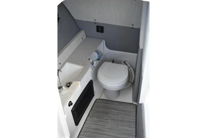 Slide: The Image of 2023 Cobalt R8 boat interior bathroom with sink, toilet, and storage space. - 25
