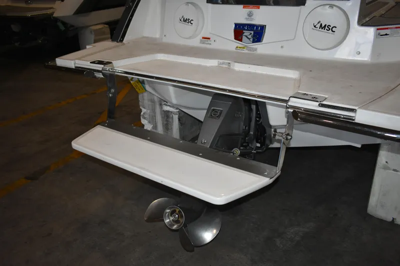 Slide: The Image of 2023 Cobalt R8 boat stern with swim platform and propeller in a garage. - 41